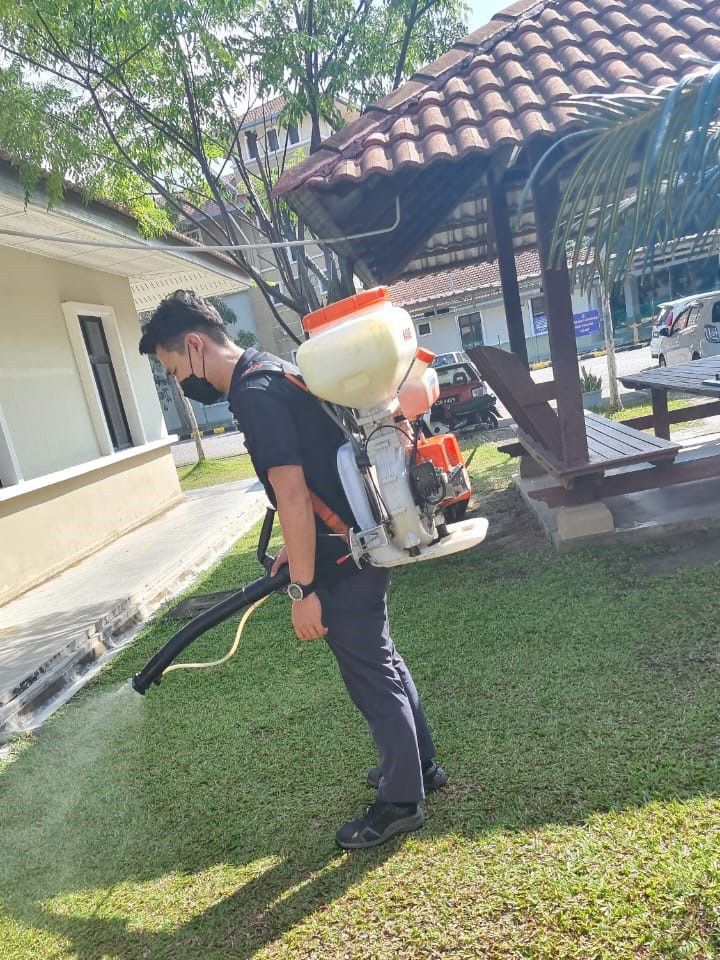 Technician misting a garden for mosquitoes